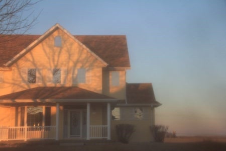 A yellow home at sunset