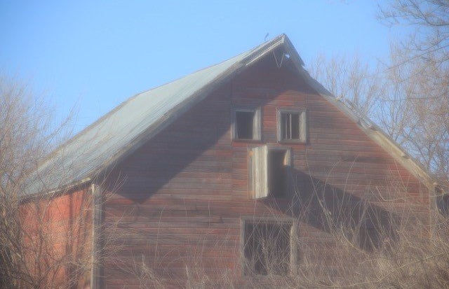 An abandoned red barn.