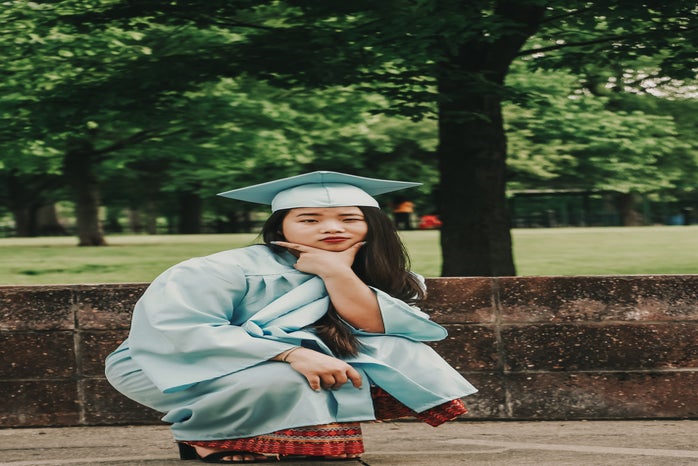 crouching woman wearing blue academic gown and hat 2335156?width=698&height=466&fit=crop&auto=webp
