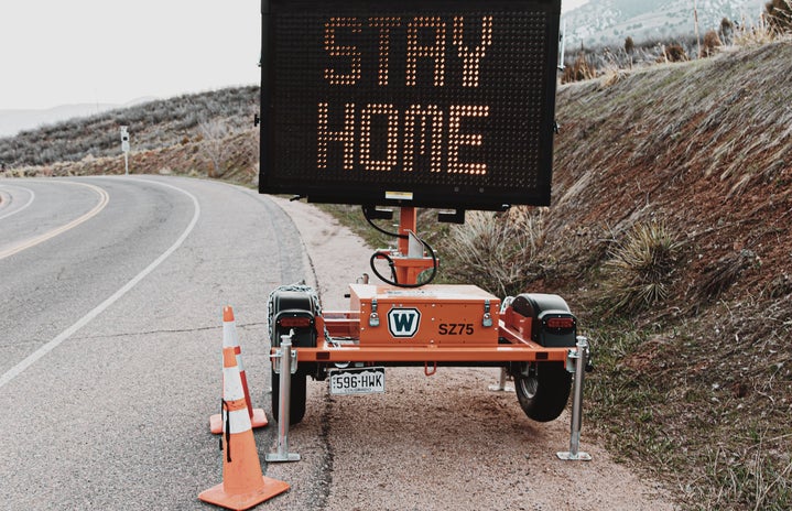 road sign that says \"stay home\"