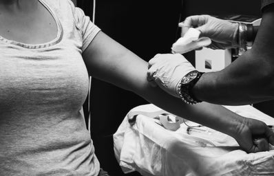 Black and white photo of girl giving blood