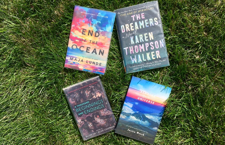 4 books in the grass horizontal photo