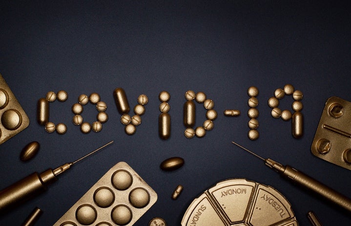 golden pills that spell out COVID-19