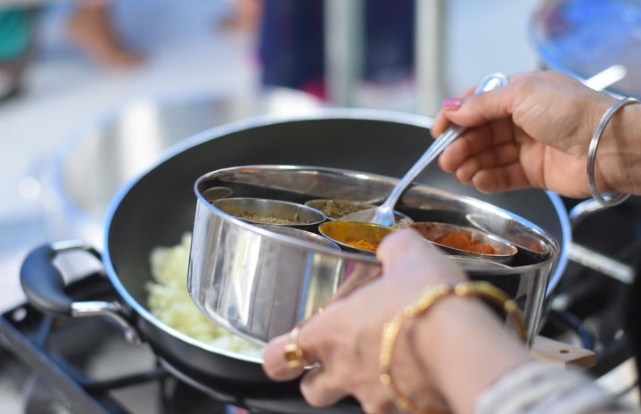 a woman cooking Indian food