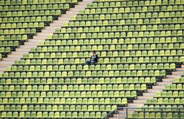 empty stadium seats with one person