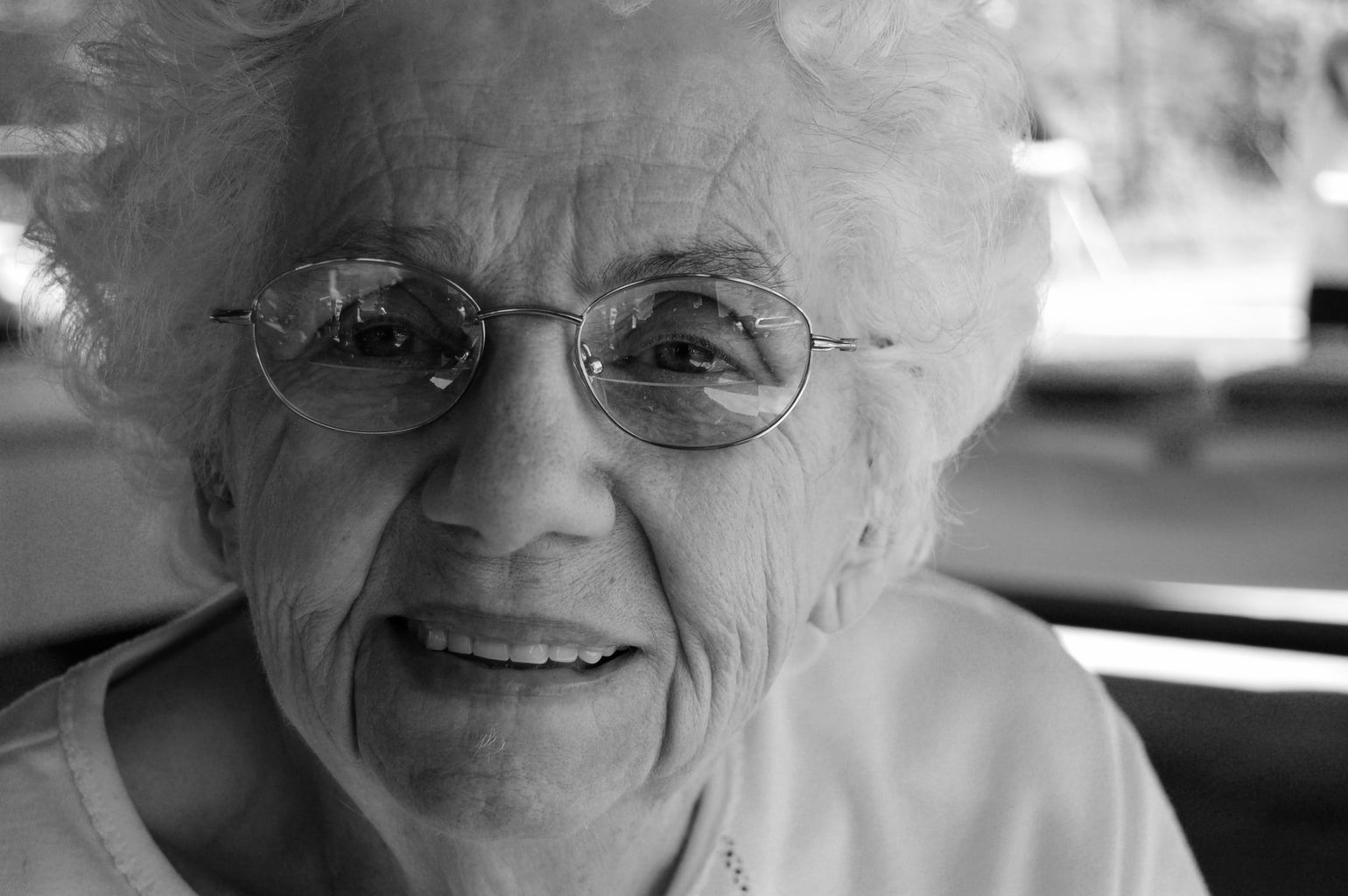 old woman with glasses smiling