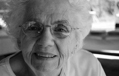 old woman with glasses smiling