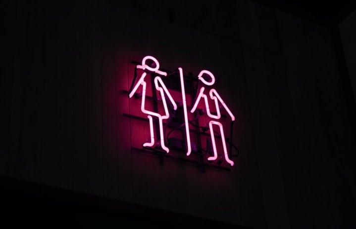 neon sign of male and female stick figures