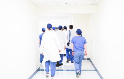 A group of doctors walking down a hallway