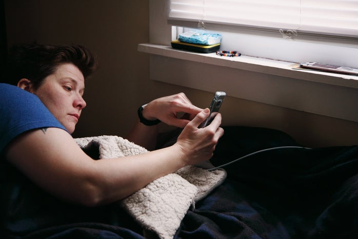 person looking at their phone while in their bed shanejpegjpg by Shane?width=698&height=466&fit=crop&auto=webp