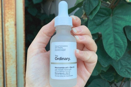 skincare product in front of leaves outside