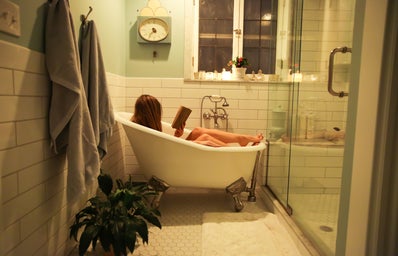 girl reading in a bath