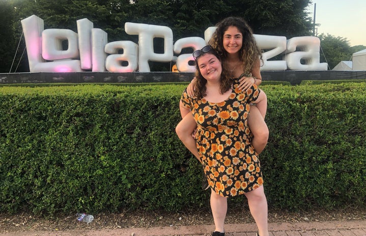 my friend and I standing in front of the Lolla sign