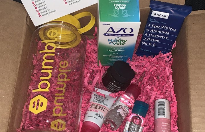 box with pink confetti and products from Garnier, Bumble, Innisfree, Azo, RXBar, and CoverGirl