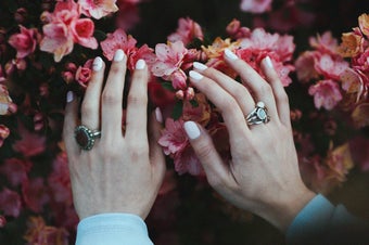 White nails against pink flowers