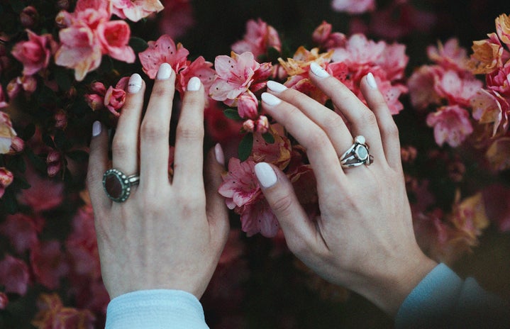 White nails against pink flowers