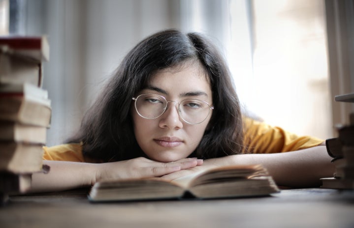 Academics 6 2020 pexels tired female student lying on book in library 3808080?width=719&height=464&fit=crop&auto=webp
