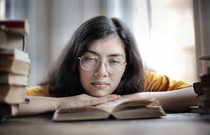 Academics 6 2020 pexels tired female student lying on book in library 3808080?width=719&height=464&fit=crop&auto=webp