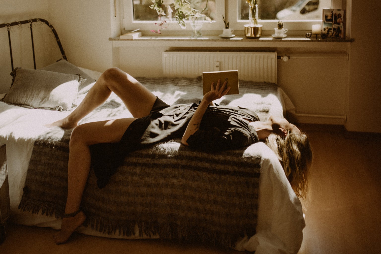 Woman reading a book in bedroom