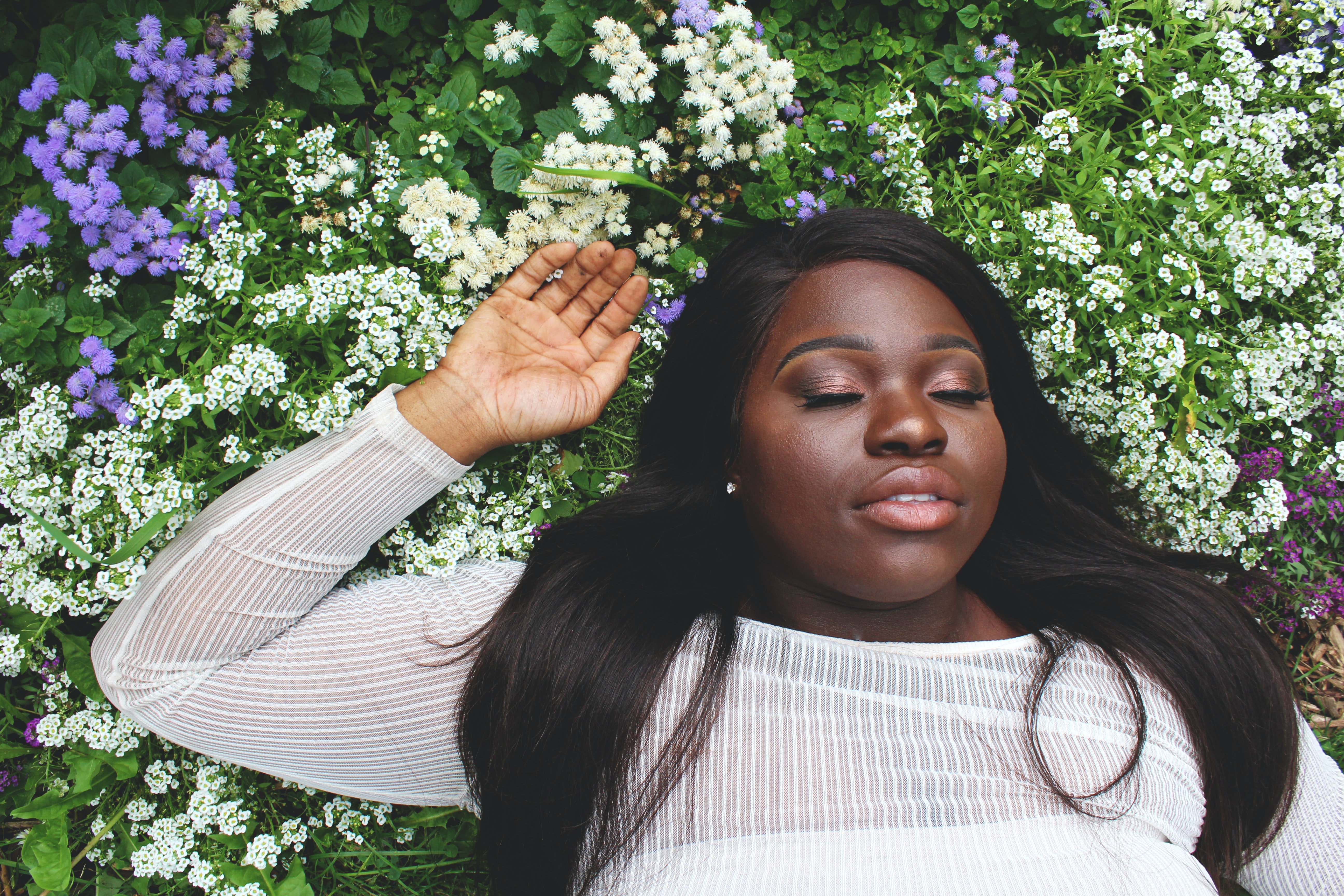 image of black woman amongst flowers