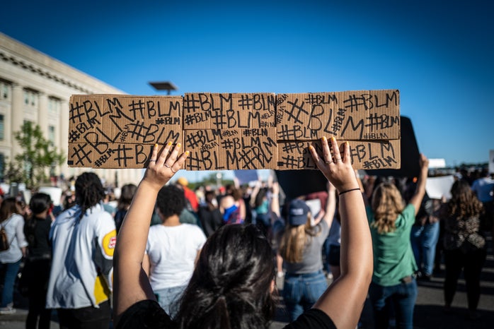 black lives matter protester holding sign