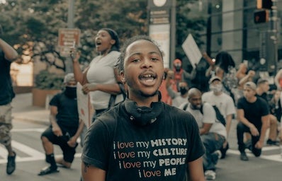 Young person in a shirt that says \"I love my history, i love my people\"