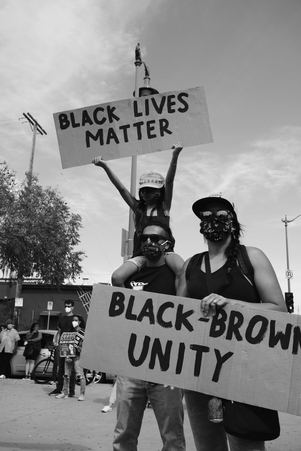 Protesters with Black Lives Matter/Black-Brown Unity signs