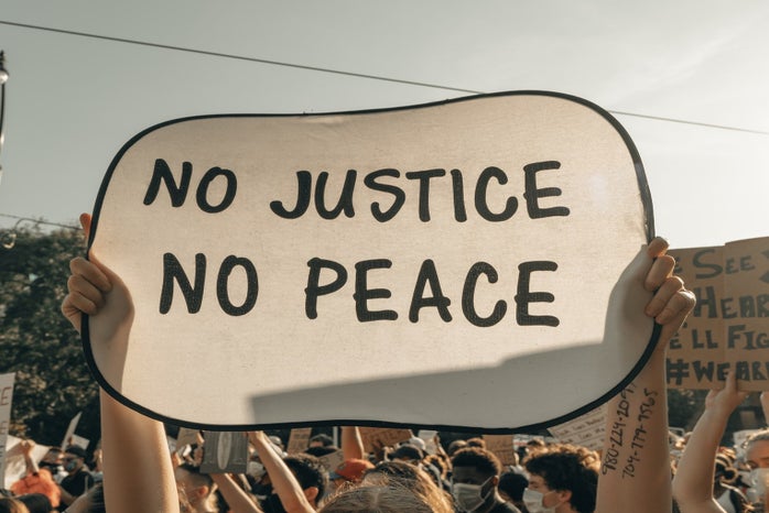 no justice no peace protest sign by Clay Banks?width=698&height=466&fit=crop&auto=webp
