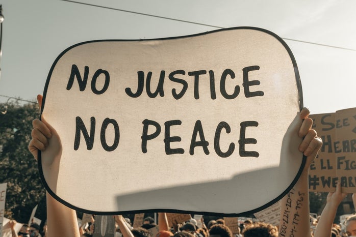 no justice no peace protest sign by Clay Banks?width=698&height=466&fit=crop&auto=webp
