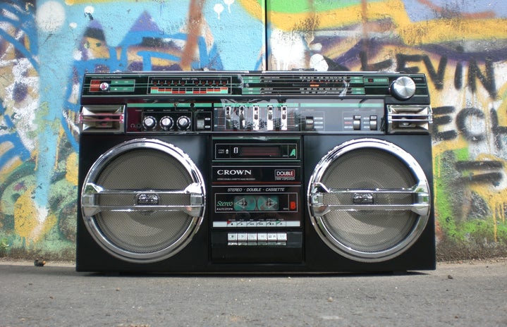 Boom box on the ground in front of a graffiti wall