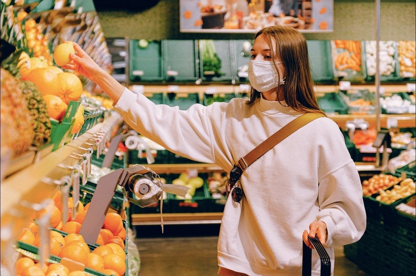 woman wearing mask while grocery shopping