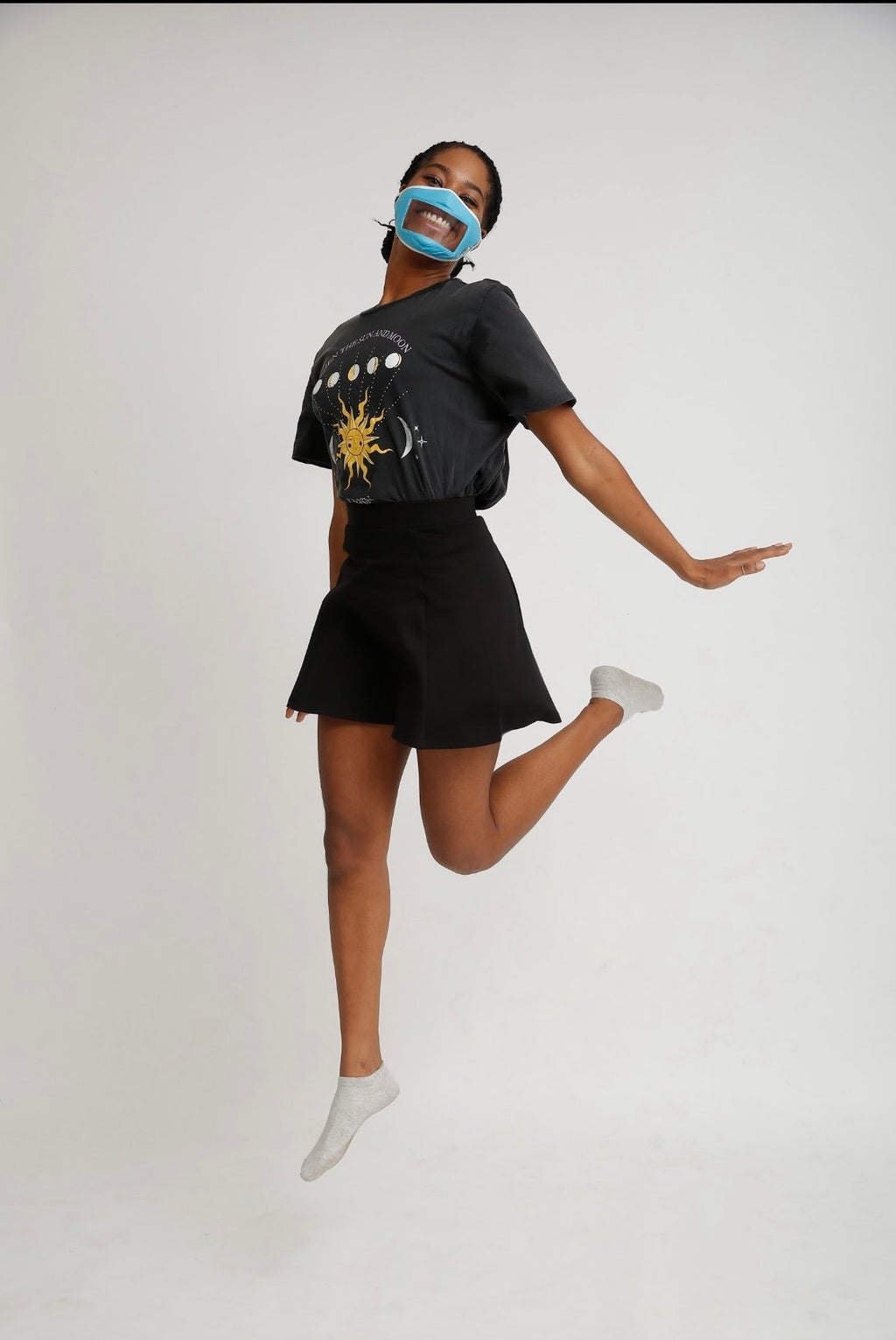 Girl jumping with smile mask