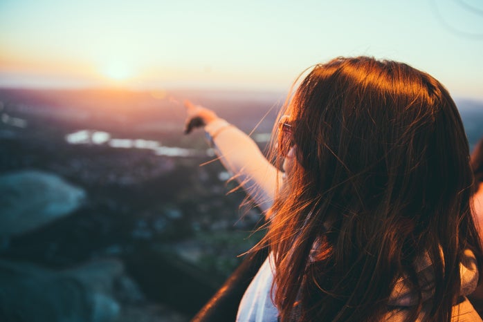 woman pointing to horizon