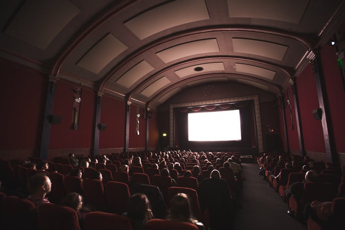 group of people looking at a movie theatre screen