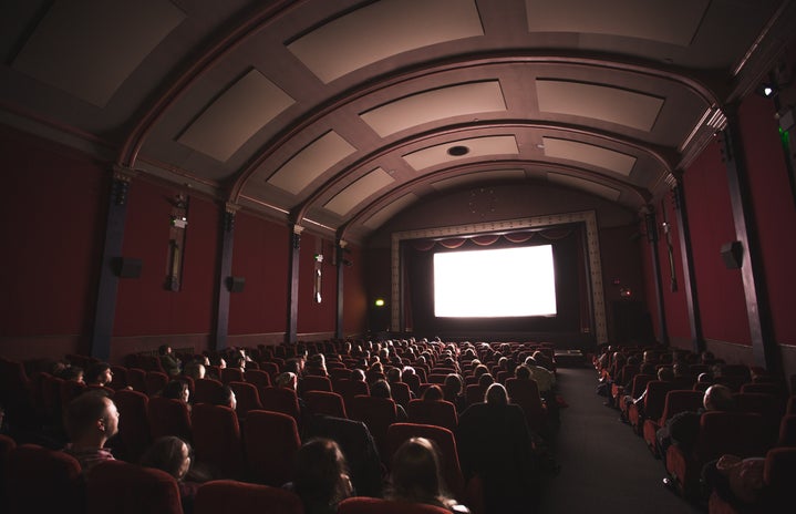 group of people looking at a movie theatre screen