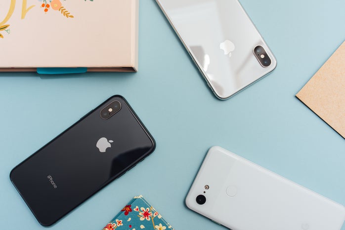 top-down view of mobile phones on blue desk
