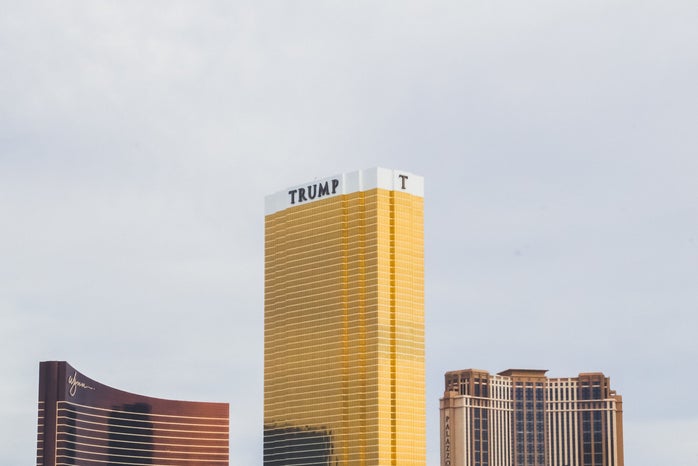 gold-colored Trump high-rise building between of two gold-colored buildings