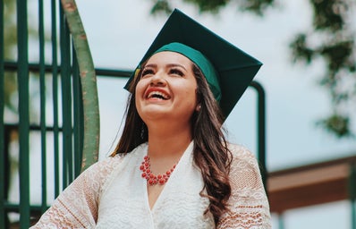 woman wearing green graduation cap