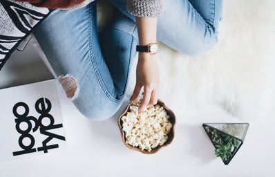 person holding popcorn on bowl