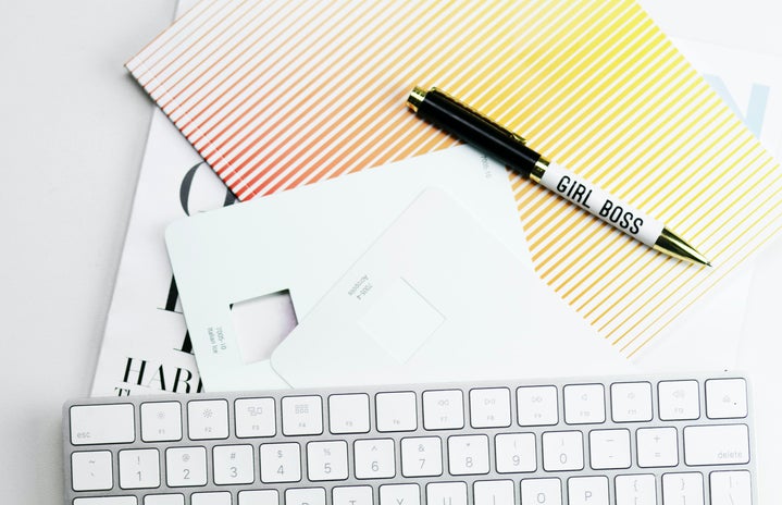 Apple Magic Keyboard, papers, and pen on white surface