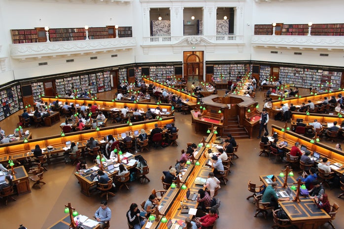 top down view of library with people sitting at desks