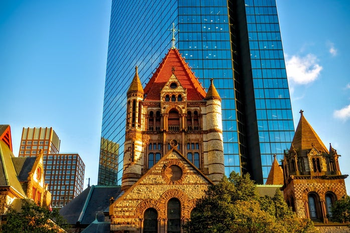Curtain-wall Building Behind Red and Beige Concrete Cathedral