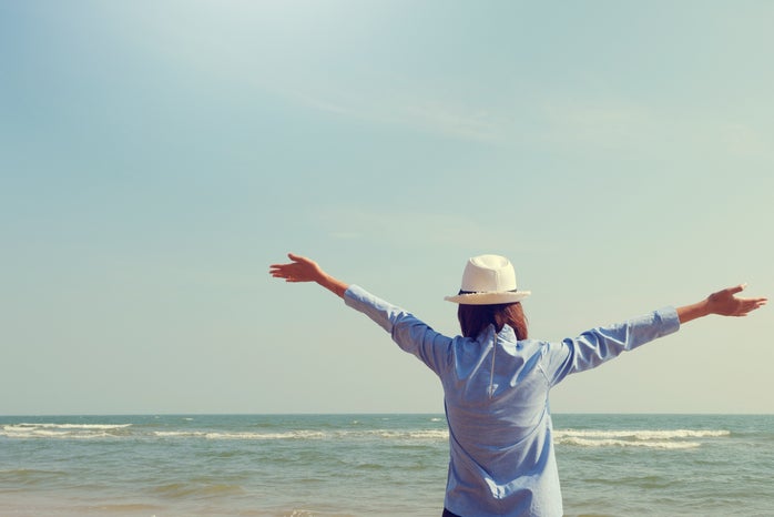 Woman Standing Facing Sea
