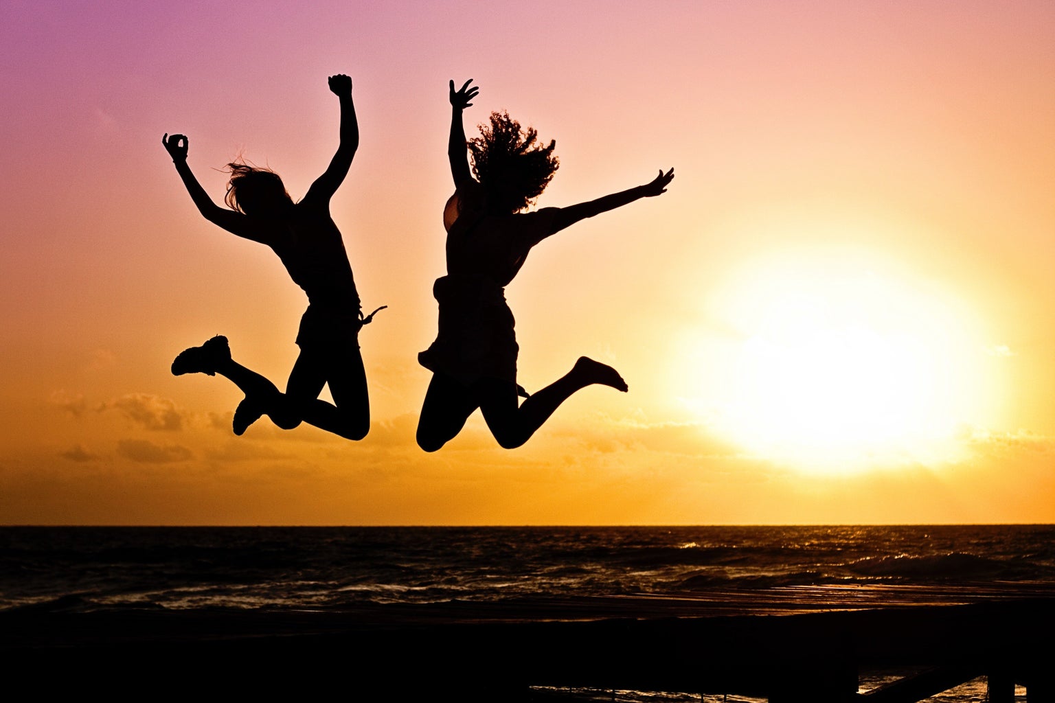 Two Person Jumping in Silhouette Photography