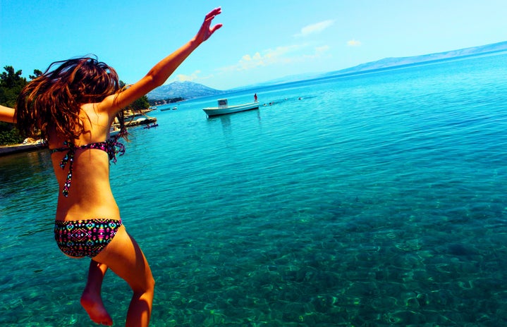 Woman Wearing Bikini Jumping to the Beach