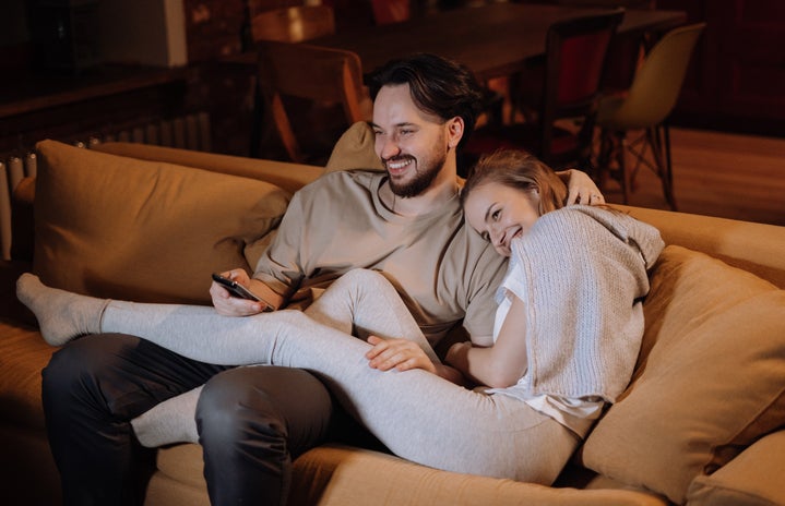 couple cuddling on the couch watching movie?width=719&height=464&fit=crop&auto=webp