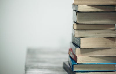 close-up of a stack of books on a grey wood table