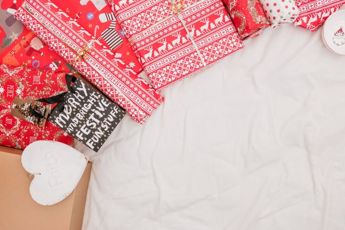 red and black packed presents on white textile