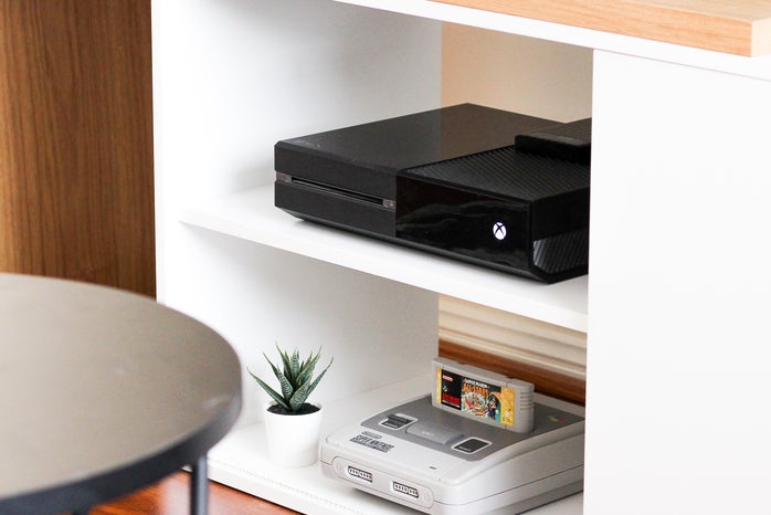 entertainment system with TV, black Xbox One, and Super Nintendo