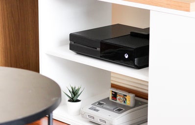 entertainment system with TV, black Xbox One, and Super Nintendo